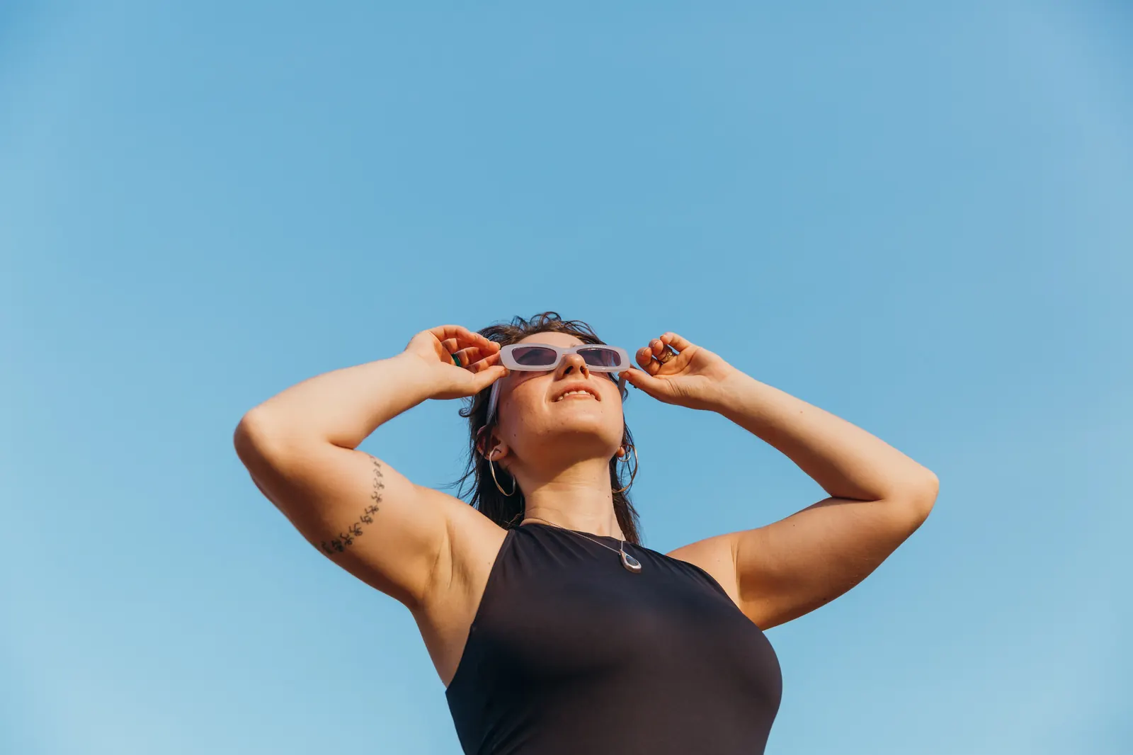 Noam in sunglasses against a blue sky